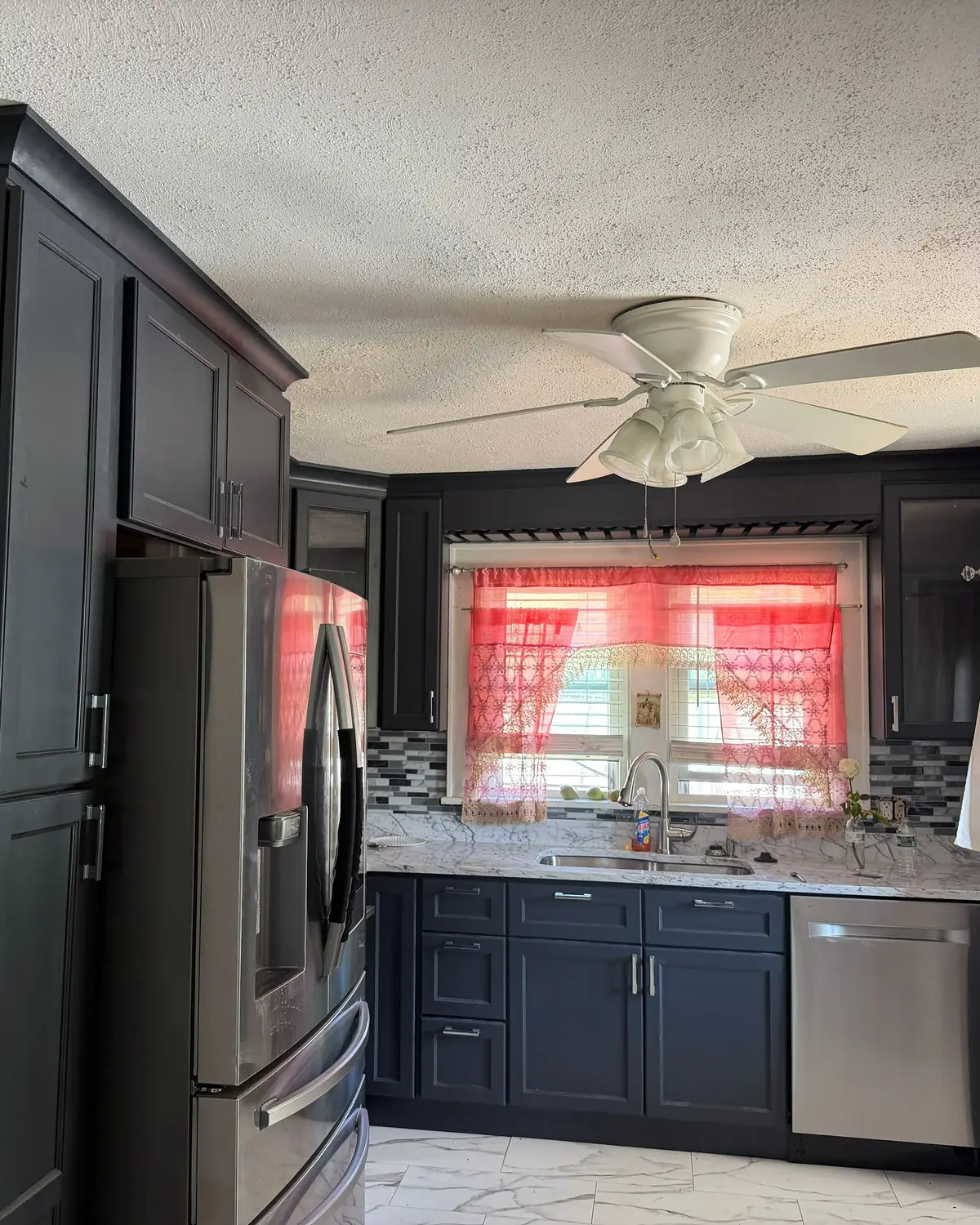 Kitchen with dark shaker cabinets, a tall pantry cabinet and stainless appliances